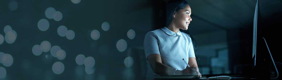 Mockup, night and overtime with a business woman at work on a deadline in a marketing office for advertising. Computer, design or dedication with a female employee working on a project in the evening